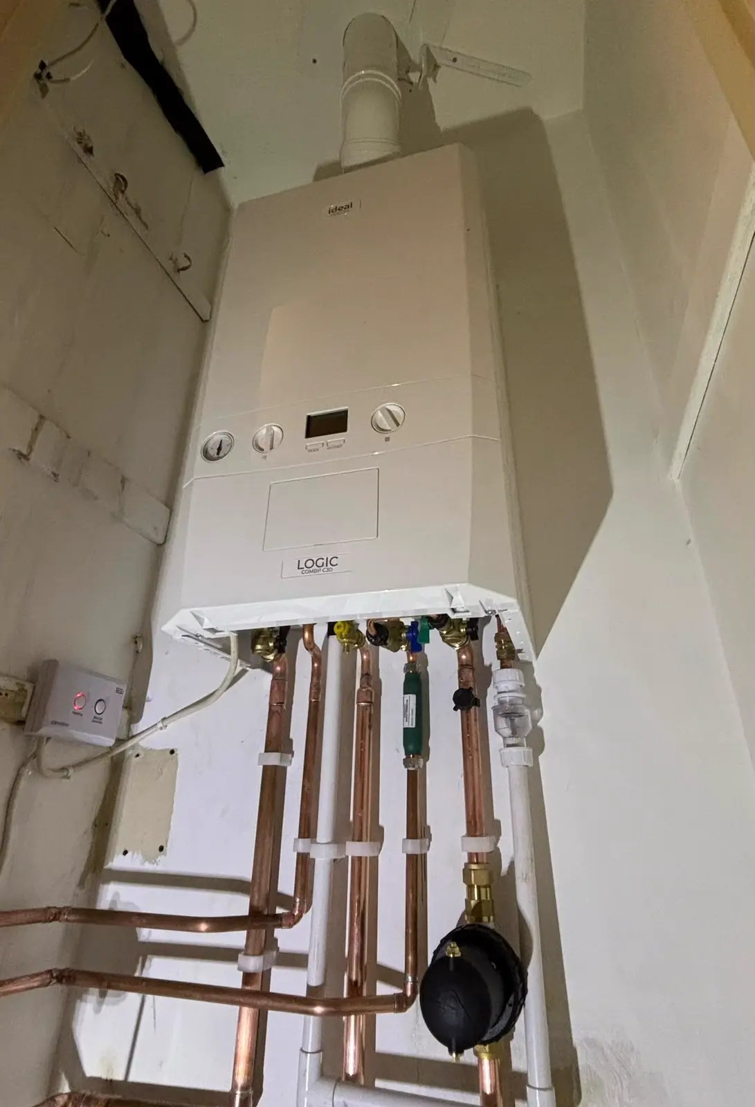 Ideal Logic combi boiler with a vertical flue, isolation valves and a magnetic filter on new copper pipework