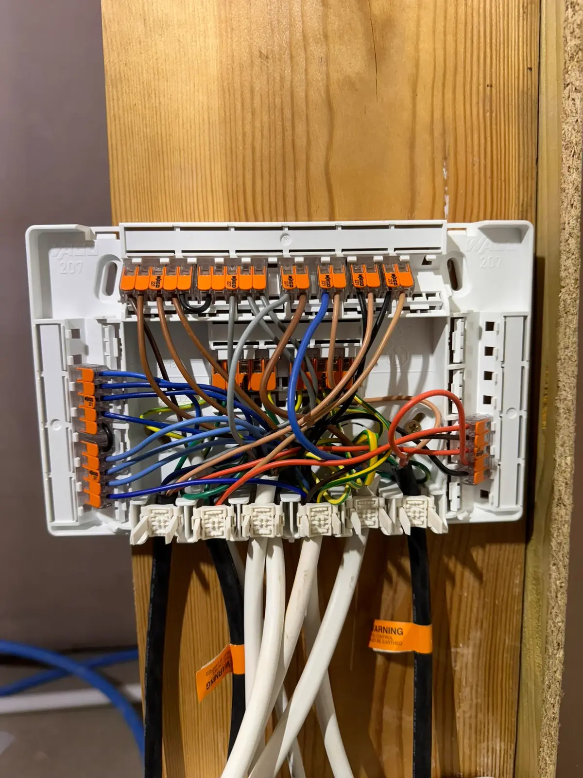 Open heating wiring centre with colour-coded cores landed in numbered terminals